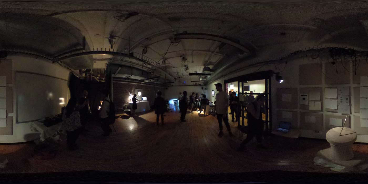 a 360 image of the hallway and people standing by projects at the show