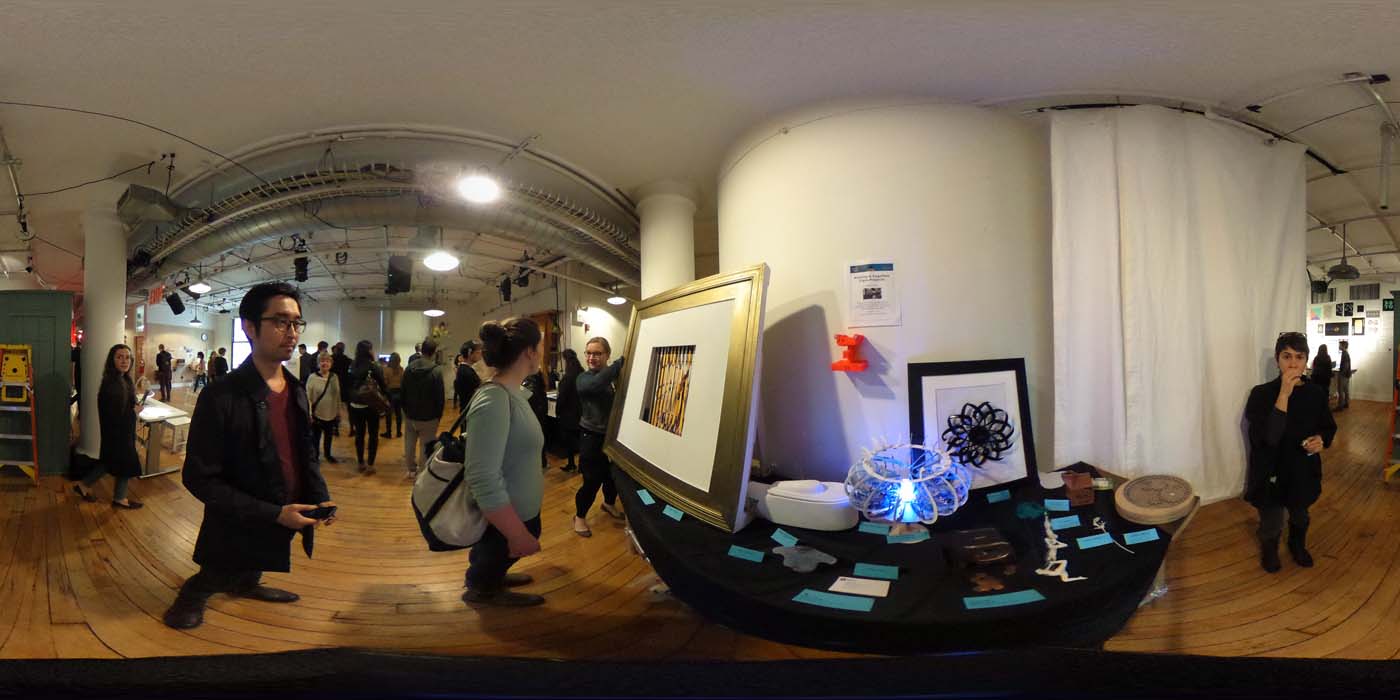 a 360 image of the hallway and people standing by projects at the show