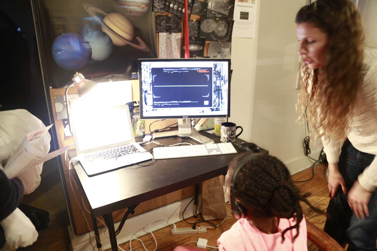 a girl wearing headphones watches a video