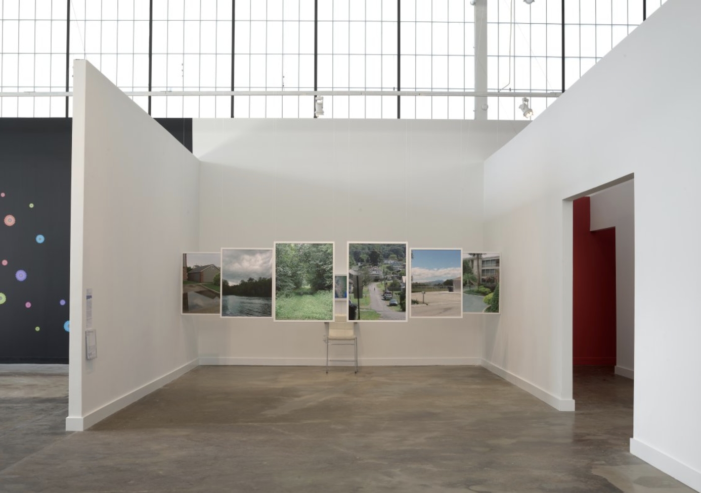 6 framed photographs installed in a room