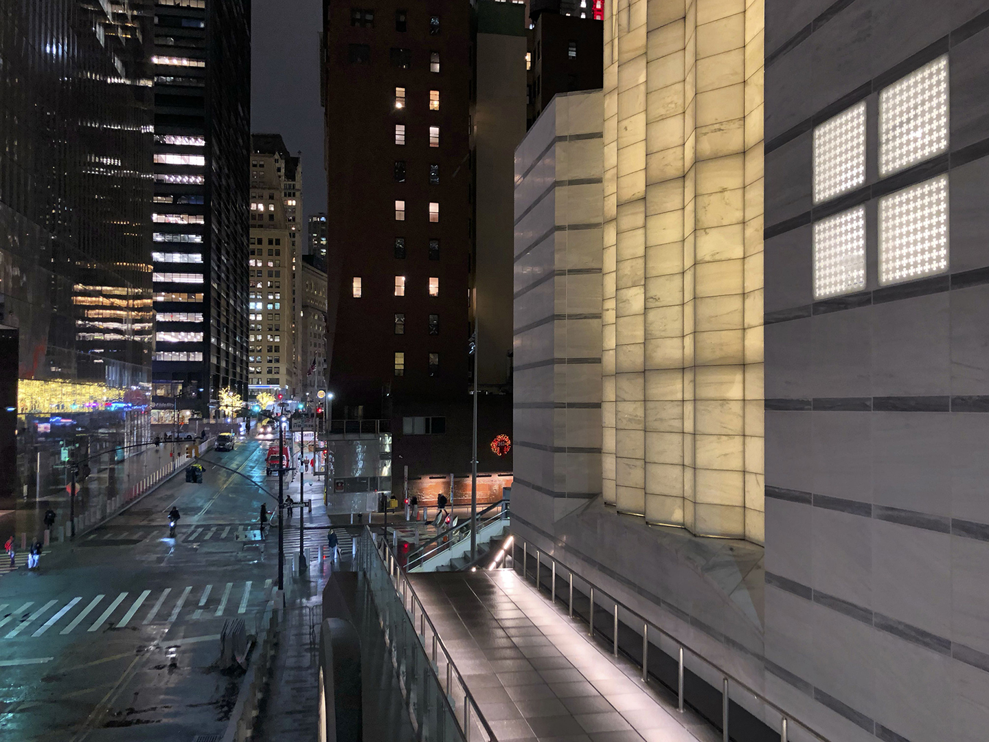 Photo of city street and buildings at night