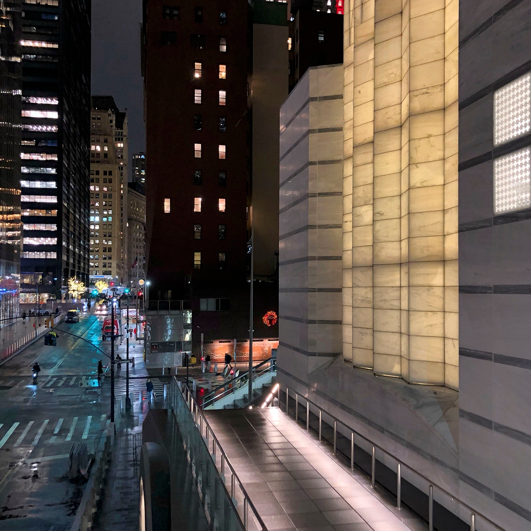 Photo of city street and buildings at night