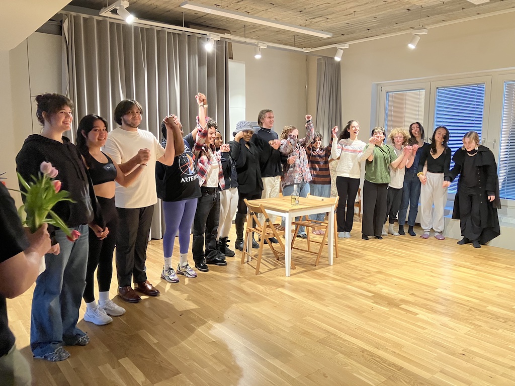 Spring 2023 Stanislavski, Brecht, and Beyond students holding hands in a curtain call bow at the end of a presentation