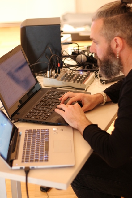 Mat Hand in front of a laptop computer