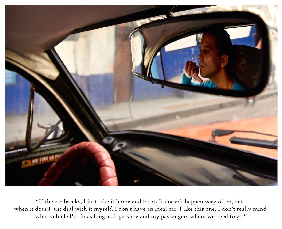 Driver's reflection in a rearview car mirror.