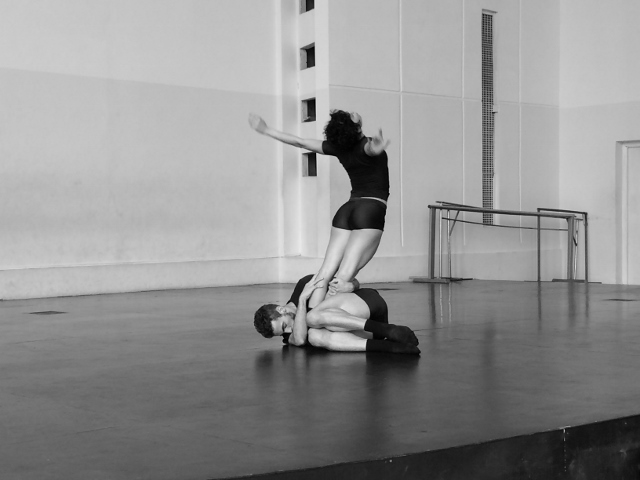 Black and white photo of two dancers in a studio.