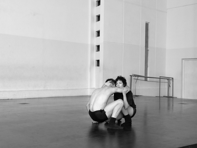 Black and white photo of two dancers in a studio.