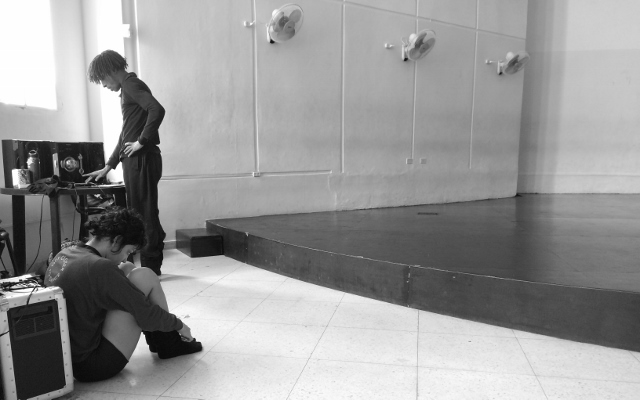 Black and white photo of a dancer in a studio.