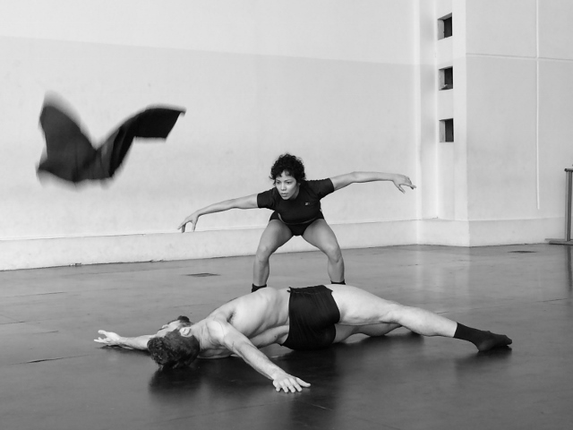 Black and white photo of two dancers in a studio.