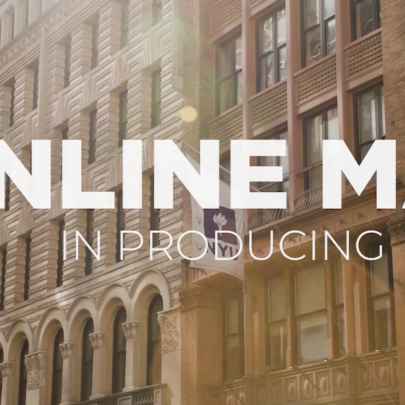 Exterior shot of buildings in New York City, with large white text overlaid, reading 'ONLINE MA in Producing'