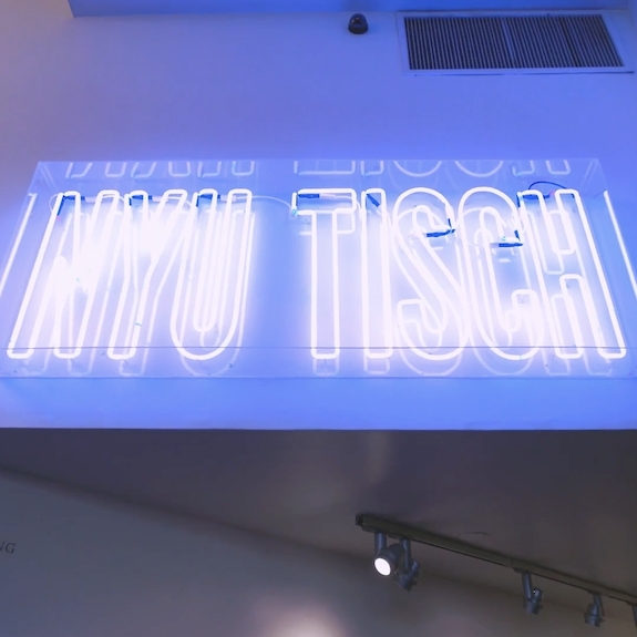 NYU TISCH neon violet sign 