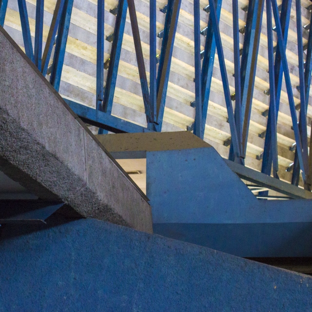 Angled photo of an outdoor staircase, taken from the back of the bannister.