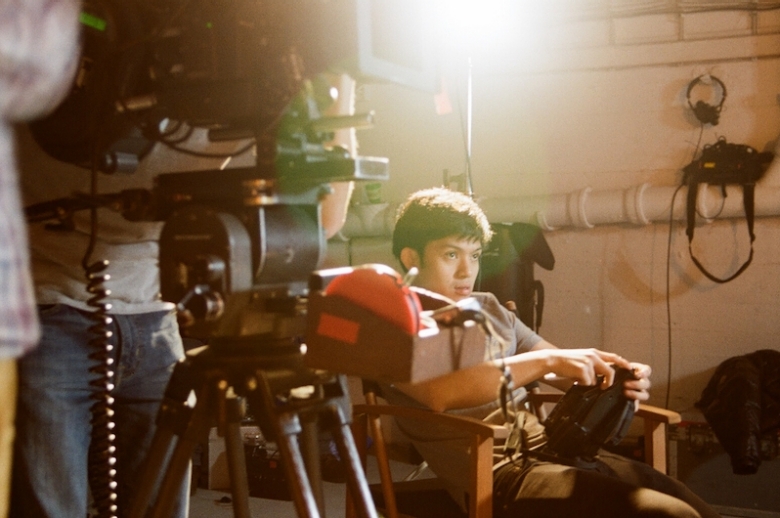 Film director in front of a 35mm camera.