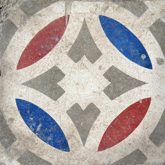 Red, blue, grey, and white geometric ceramic tiles in Havana.